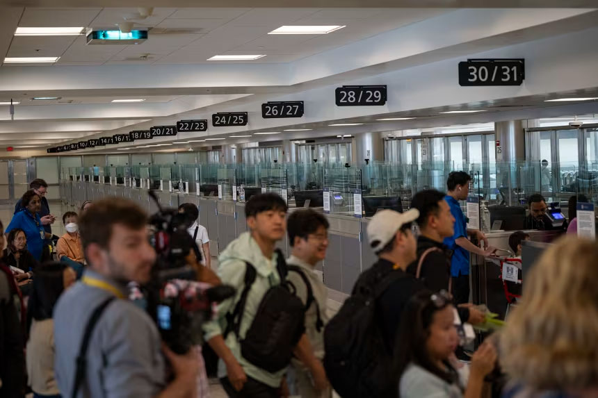 Travelers at Dulles International Airport in Virginia are pictured during a media event related to incoming foreign nationals on June 29, 2025. Celal Gunes/Anadolu Agency/Getty Images