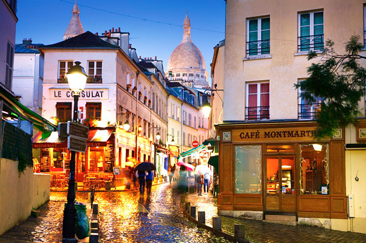 Dome of Sacre Coeur de Montmartre seen above cobbled street at night &copy; Matt Munro / Lonely Planet